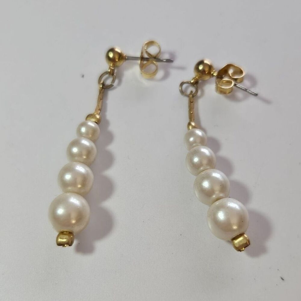 Gold tone dangling stacked faux pearl earrings